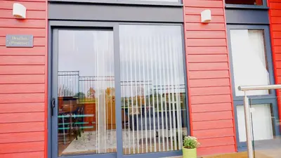 a store front with a sliding glass door at Nantsidyll Farm Spa & Holiday Lodges in Mydroilin