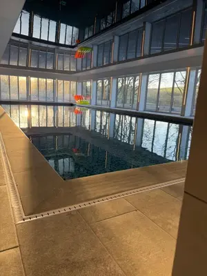 a large building with a pool in the middle at Nantsidyll Farm Spa & Holiday Lodges in Mydroilin