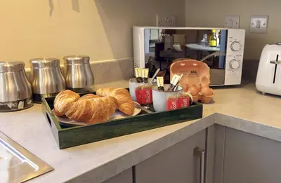 a tray of croissants on a counter in a kitchen at Elegant interior-designed ground floor apartment - Pass the Keys in Shrewsbury