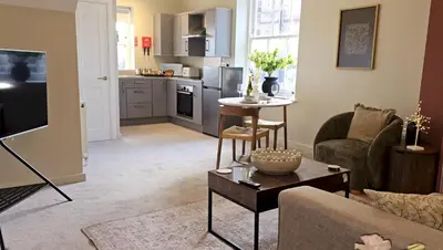 a living room with a couch and a table at Elegant interior-designed ground floor apartment - Pass the Keys in Shrewsbury