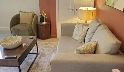a living room with a couch and a table at Elegant interior-designed ground floor apartment - Pass the Keys in Shrewsbury