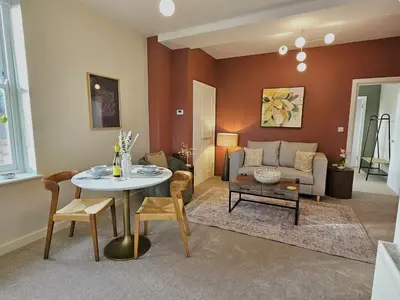 a living room with a table and a couch at Elegant interior-designed ground floor apartment - Pass the Keys in Shrewsbury