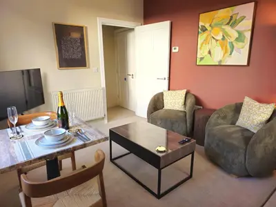 a living room with a table and chairs and a tv at Contemporary first-floor apartment close to town - Pass the Keys in Shrewsbury
