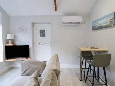 a living room with a couch and a table at Lodge at Nadur in Machynlleth