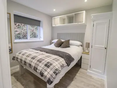 a bedroom with a bed and a window at Lodge at Nadur in Machynlleth