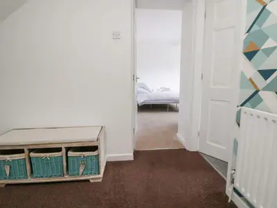 a room with a bedroom with a bed and a door at Castellolwg in Llangollen