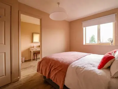 a bedroom with a bed and a window and a desk at 2 Horseshoe Road in Montgomery