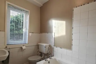 a bathroom with a toilet and a sink and a mirror at 2 Bed in Llanelltyd oc-s34505 in Llanelltyd