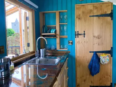 a kitchen with a sink and a wooden door at 1 Bed in Llanfihangel-y-Creuddyn oc-c34624 in Llanfihangel-y-creuddyn