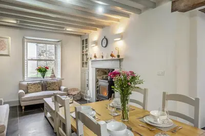a dining room with a table and a fireplace at 3 Bed in Islawrdref oc-t34600 in Penmaenpool