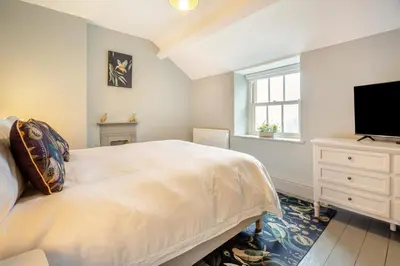 a bedroom with a bed and a flat screen tv at 3 Bed in Islawrdref oc-t34600 in Penmaenpool