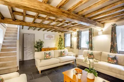 a living room with white furniture and wooden ceilings at 4 Bed in Ganllwyd oc-g34601 in Mallwyd