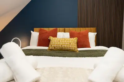 a bedroom with a bed with colorful pillows at Professionals welcome - Near Town Centre - Free Parking-Sleeps 4 in Shrewsbury