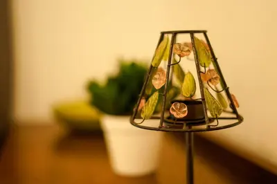 a lamp with flowers on it next to a plant at FLAT 2 Seven Cambrian Square First Floor Flat in Newtown