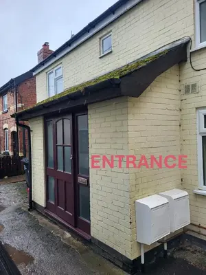 a brick building with an entrance sign on it at FLAT 2 Seven Cambrian Square First Floor Flat in Newtown