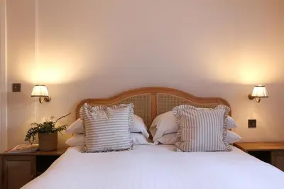 a bedroom with a white bed with white pillows at Spacious Luxury Apartment in the Heart of Shrewsbury Sleeps 6 in Shrewsbury