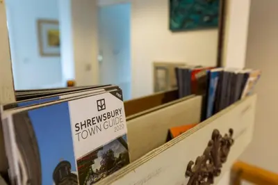 a sign that is on a shelf with books at Spacious 4 bed home to sleep 9, parking for 4 cars in Shrewsbury