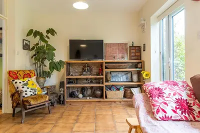a living room with a couch and a flat screen tv at Spacious 4 bed home to sleep 9, parking for 4 cars in Shrewsbury