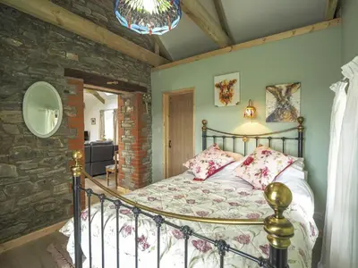 a bedroom with a bed in a room at Sgubor Delyn Aberystwyth in Llanrhystyd