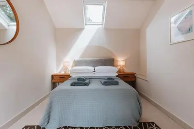 a bedroom with a bed with two towels on it at Little Whitley - Luxury Country Cottage in Shrewsbury