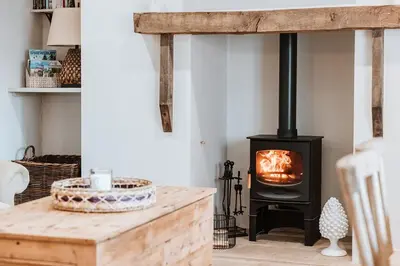 a fireplace in a living room with a wood stove at Little Whitley - Luxury Country Cottage in Shrewsbury