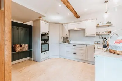 a kitchen with white cabinets and white appliances at Little Whitley - Luxury Country Cottage in Shrewsbury