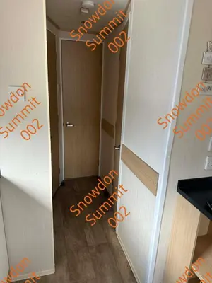 a hallway with orange writing on the walls of a room at Snowdon Summit 002 in Barmouth