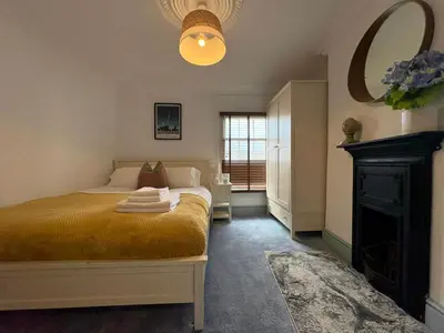 a bedroom with a bed and a fireplace at Charming 2 Bed House in Central Shrewsbury in Shrewsbury