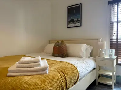 a bedroom with a bed with towels on it at Charming 2 Bed House in Central Shrewsbury in Shrewsbury