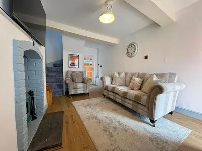 a living room with a couch and a fireplace at Charming 2 Bed House in Central Shrewsbury in Shrewsbury
