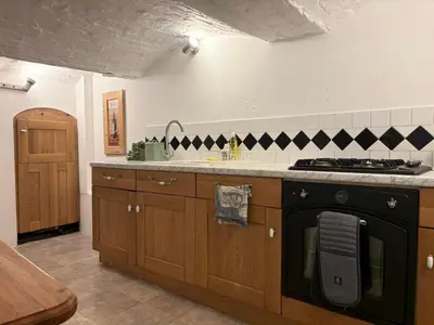 a kitchen with a stove and a sink at Charming 2 Bed House in Central Shrewsbury in Shrewsbury