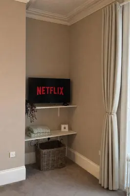 a living room with a netflix sign on a wall at Swn Y Mor 3 Aberystwyth in Aberystwyth
