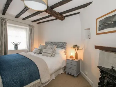 a bedroom with a large bed and a window at 8 Welsh Street in Bishops Castle