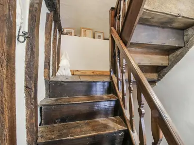 a wooden staircase in a house with wooden floors at 8 Welsh Street in Bishops Castle