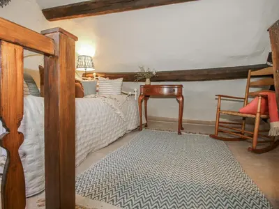 a bedroom with a bed and a table and a chair at 8 Welsh Street in Bishops Castle