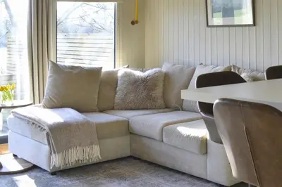 a white couch in a living room with a table at Lavender Lodge