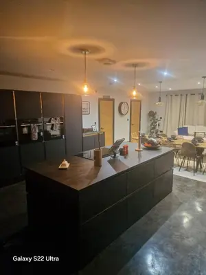 a kitchen with a large island in the middle at Luxurious 5-Bedroom House Rental with Scenic Countryside Views in Hereford