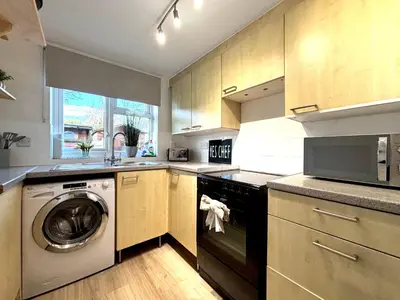 a kitchen with a washer and a dishwasher at 2 bedroom house 12mins walk to town in Shrewsbury