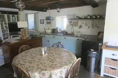 a kitchen with a table and a kitchen with a counter at Welsh Hideaways in Pentre-briwnant