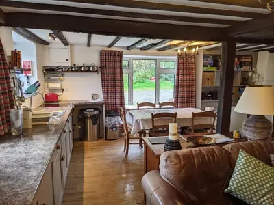 a kitchen and living room with a couch and a table at Welsh Hideaways in Pentre-briwnant