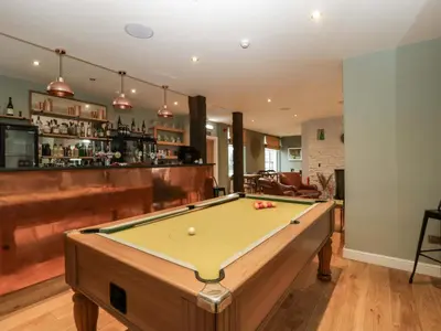 a room with a pool table and a bar at The Swan in Hereford