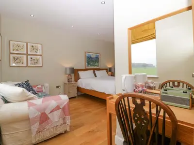 a bedroom with a bed and a table and a couch at The Swan in Hereford