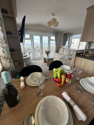 a dining room table with a bowl of fruit on it at Dolphin View in Llanddwywe