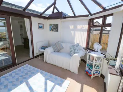 a living room with a white couch and windows at Goetra in Harlech