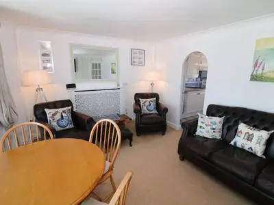 a living room with couches and a table and chairs at Goetra in Harlech
