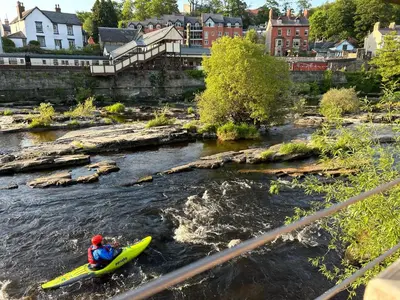 a person in a kayak in a river at Henllys Cottage in Corwen