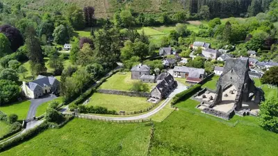an aerial view of a small village with a mansion at Abbey Cottages - Buzzards Watch in Talley