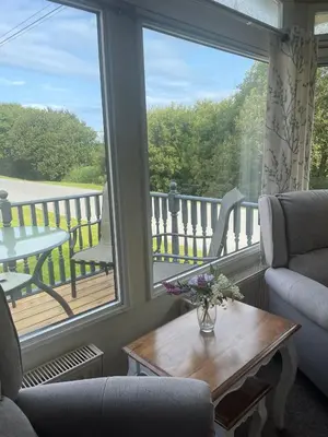 a living room with a view of a balcony at Family 3 Bedroom Caravan at Clarach Bay in Aberystwyth