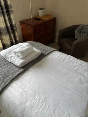 a bedroom with a bed with two towels on it at Hazeldene Guest House in Aberaeron