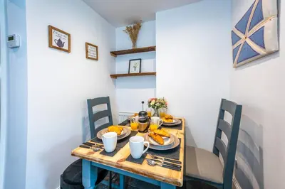 a table with plates of food on it at Quaint home with log burner in peaceful cul-de-sac in Shrewsbury